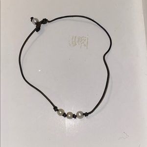 Black leather choker with three white pearls
